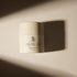 A jar of Futura Genò Crema by Purabeauti positioned on a surface with a shadow cast over it.