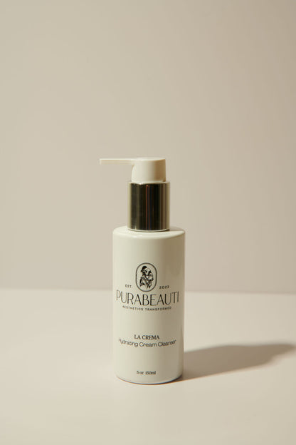 A pump bottle of Purabeauti La Crema cleanser against a neutral background.