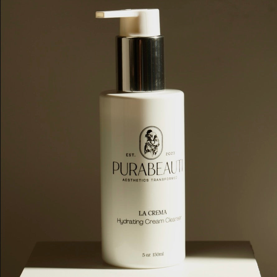 Purabeauti La Crema hydrating cream cleanser bottle on a brown background