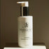 Purabeauti La Crema hydrating cream cleanser bottle on a brown background