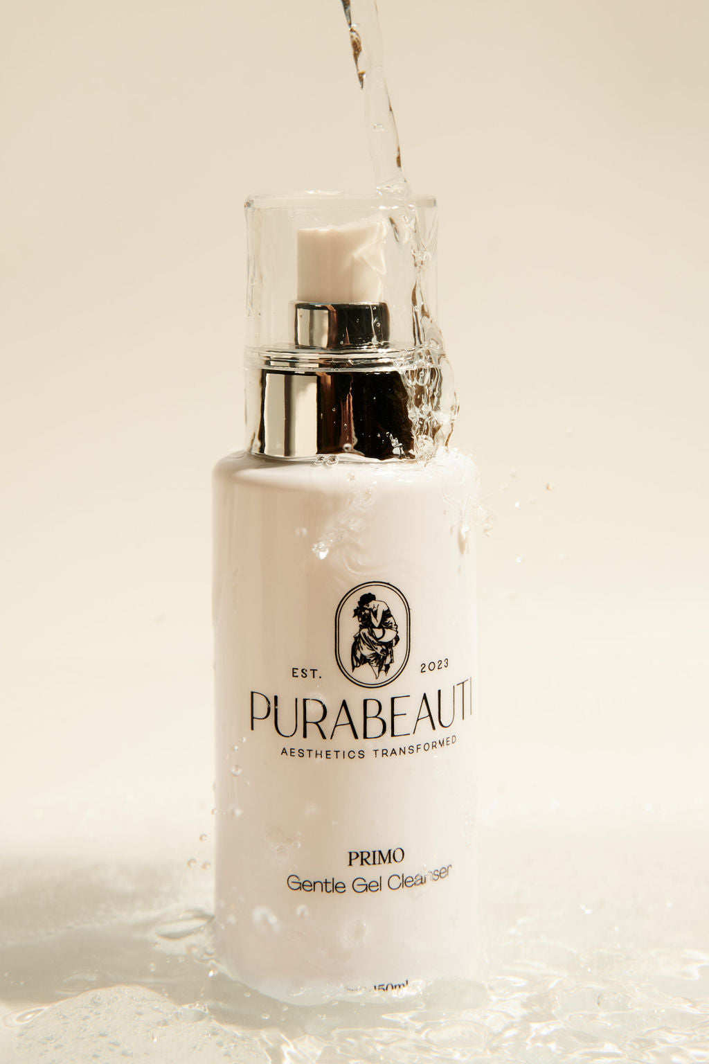 PurabeautI Primo Cleanser gel low foam cleanser skincare product bottle with silver cap on a beige background